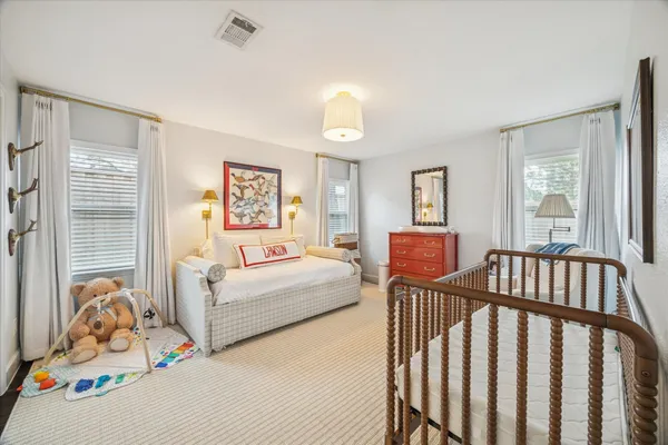 a bedroom with furniture and a window