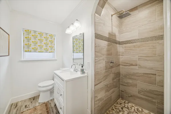 a bathroom with a sink a toilet and shower