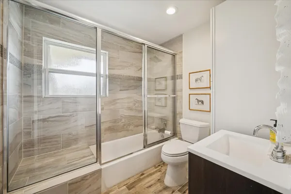 a bathroom with a shower toilet and sink