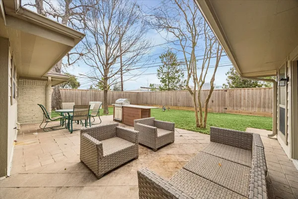 a view of a patio with couches and a fire pit