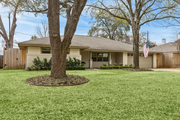 a front view of house with a garden