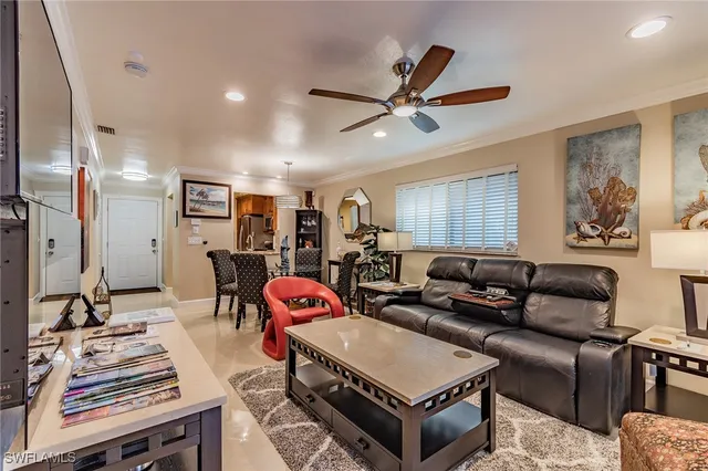 a living room with furniture a air conditioner and a window