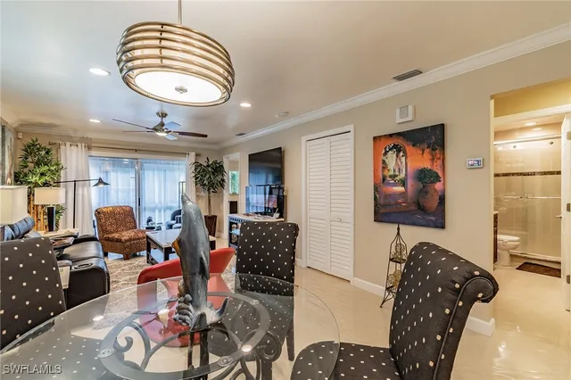 a living room with furniture piano and wooden floor