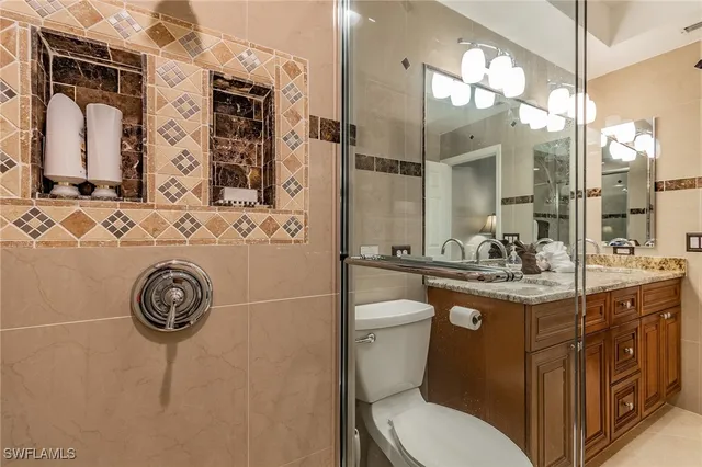 a bathroom with a toilet a sink and mirror