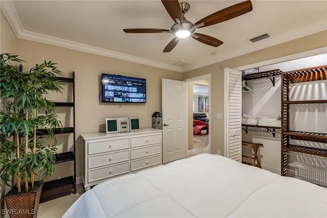 a bedroom with a large bed and a chandelier