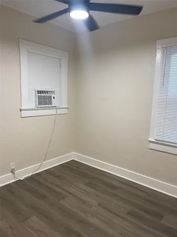 a view of a room with wooden floor and windows