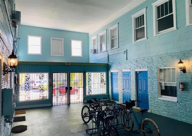 a living room with furniture a flat screen tv and windows