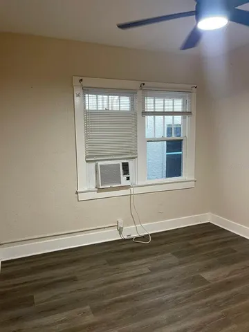 a front view of a house with wooden floor and a window