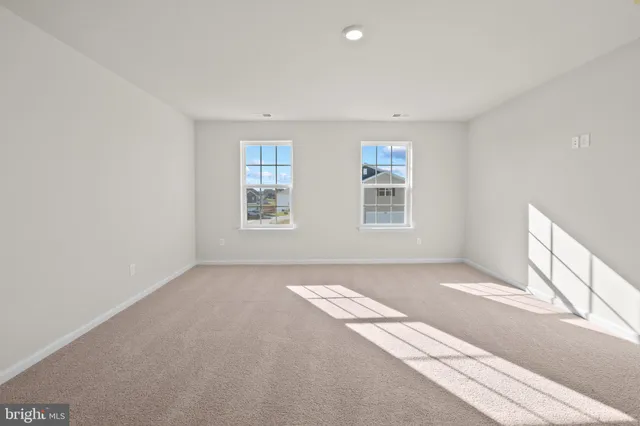 a view of an empty room with windows