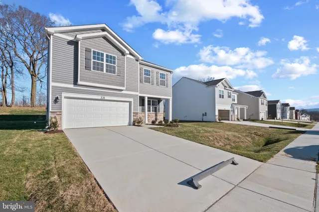 a view of a white house with a yard