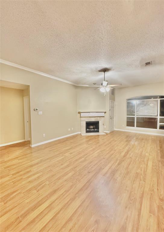 4005 Ridge Rock Drive Plano, TX 75074 - Photo 1 of 13 a view of empty room with wooden floor and fireplace