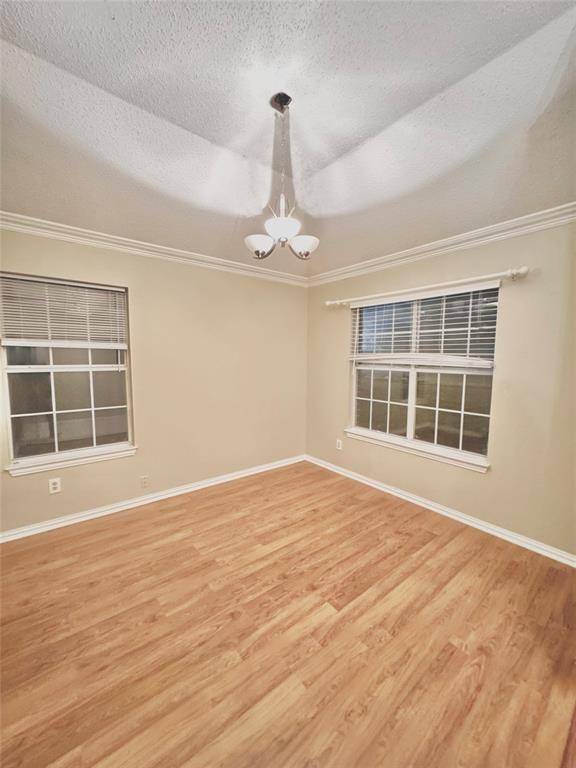 4005 Ridge Rock Drive Plano, TX 75074 - Photo 3 of 13 a view of an empty room with a window and wooden floor