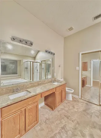 a spacious bathroom with a granite countertop sink and a mirror