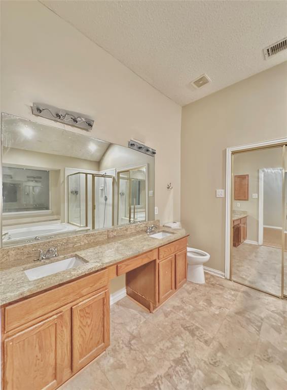 4005 Ridge Rock Drive Plano, TX 75074 - Photo 8 of 13 a spacious bathroom with a granite countertop sink and a mirror