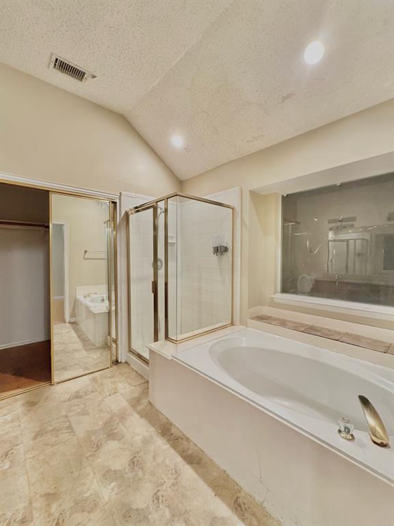 4005 Ridge Rock Drive Plano, TX 75074 - Photo 9 of 13 a spacious bathroom with a tub and shower