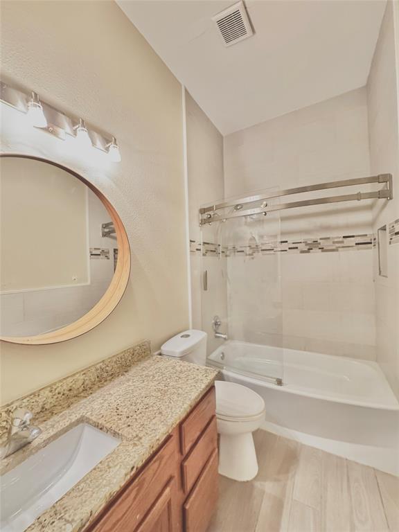 4005 Ridge Rock Drive Plano, TX 75074 - Photo 10 of 13 a bathroom with a granite countertop sink a toilet and bathtub