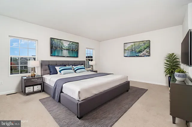a bedroom with bed and a potted plant