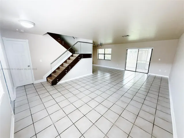 a view of an empty room and stairs