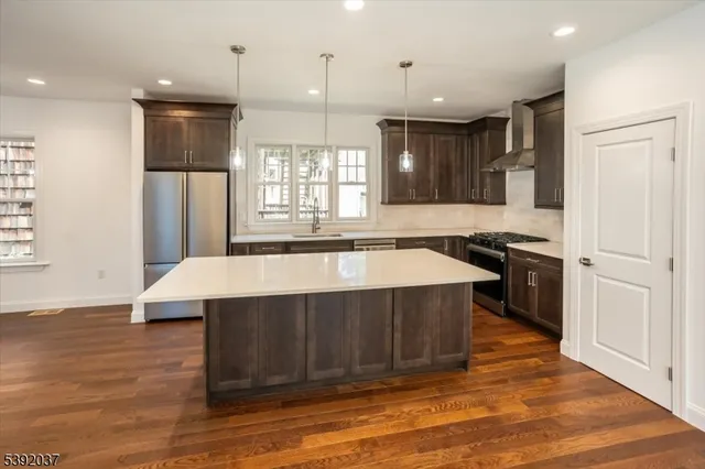 a kitchen with a stove a refrigerator and a sink