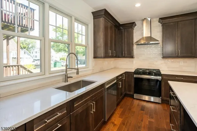 a kitchen with a sink stove top oven and cabinets