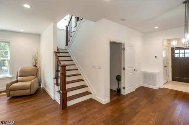a view of a livingroom with wooden floor and furniture
