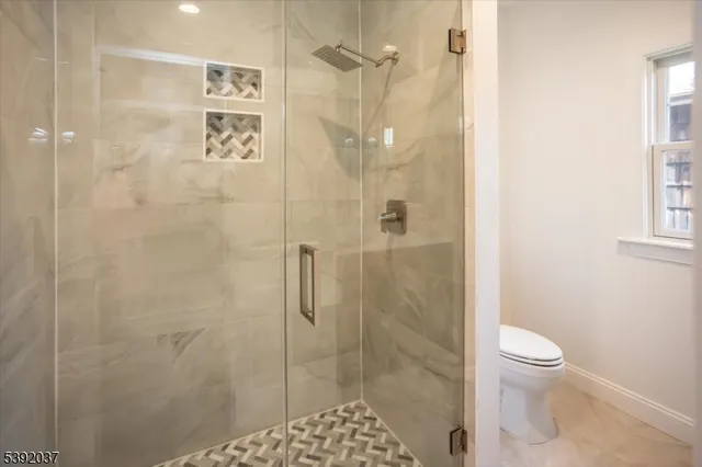 a bathroom with a shower and a toilet