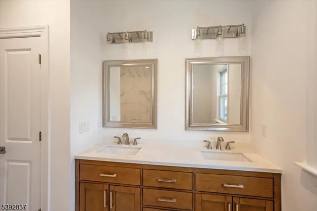a bathroom with 2 sink and a mirror