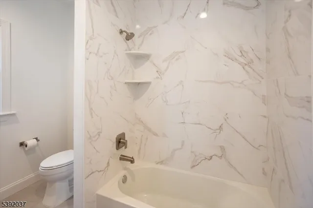 a bathroom with a bathtub and a toilet