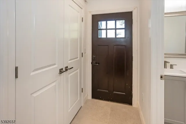 a view of an entryway with wooden floor