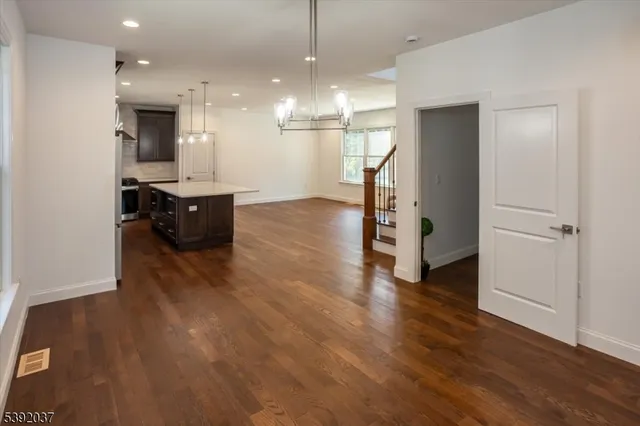 a view of a kitchen and wooden floor