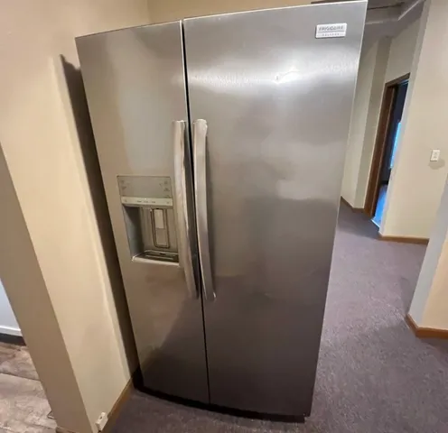 a stove top oven sitting inside of a kitchen