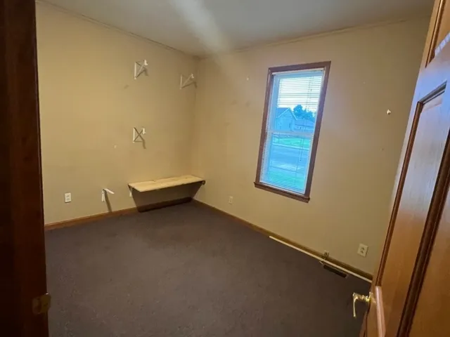 a view of room with window and a bathroom