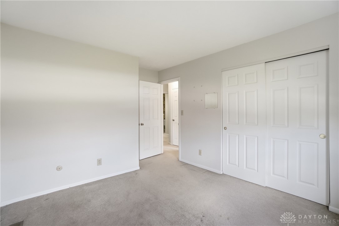 9964 Hummingbird Way Dayton, OH 45458 - Photo 39 of 57 This spacious bedroom offers ample natural light, soft carpeting, and a neutral palette.