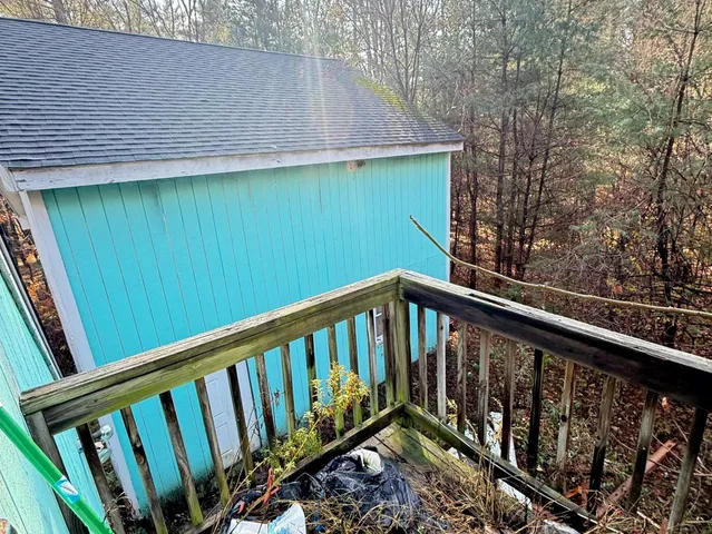 a view of a balcony with wooden fence and floor