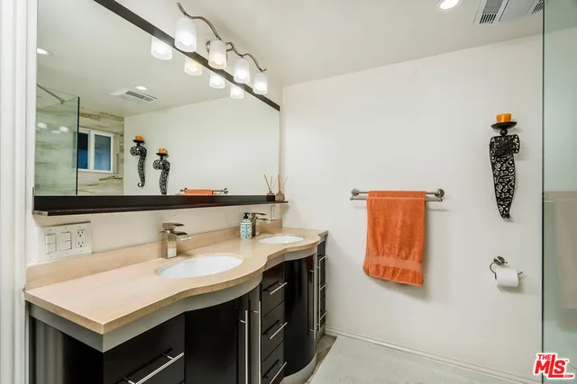 a bathroom with a sink vanity and a mirror