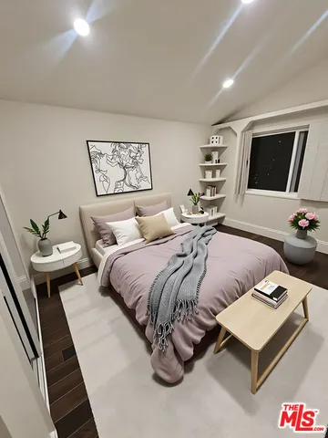 a bedroom with a bed and a couch