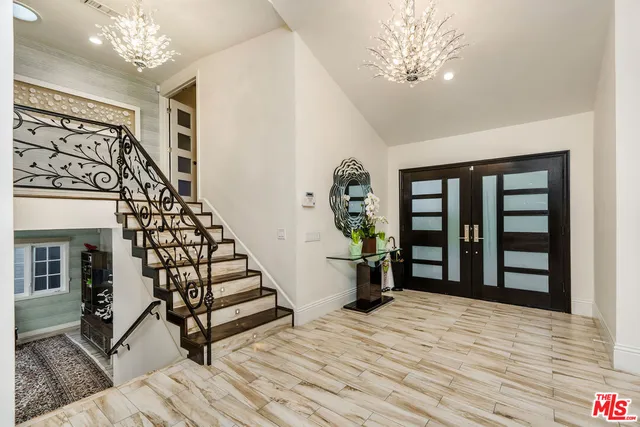 a view of entryway with stairs and wooden floor