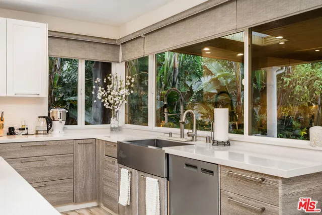 a kitchen with a sink and large window