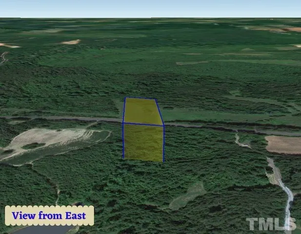 a view of a golf ground with huge green field and plants