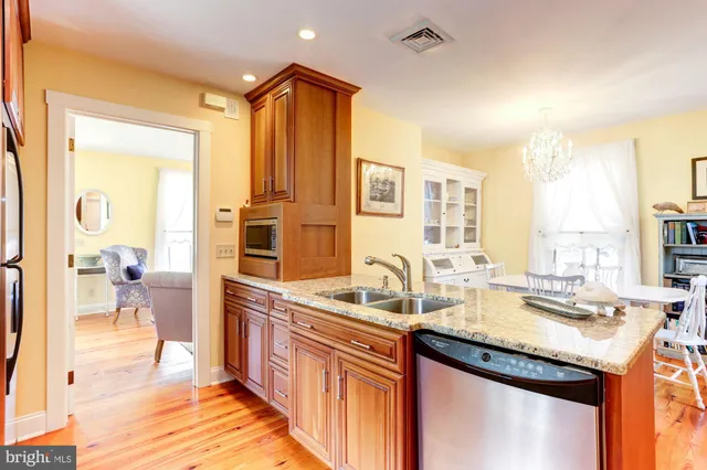 a kitchen with sink refrigerator and cabinets