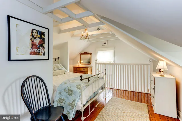 a view of a hallway to a livingroom with furniture