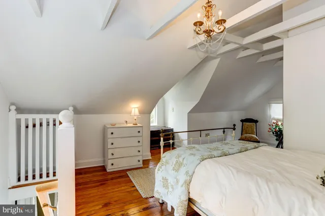 a bed room with a bed and a chandelier