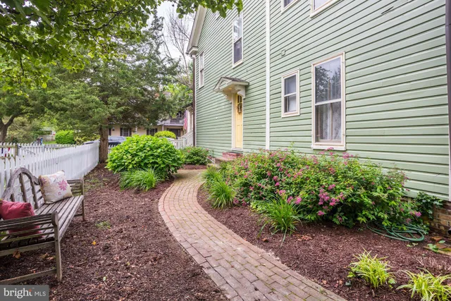 a patio with a table and chairs under an umbrella