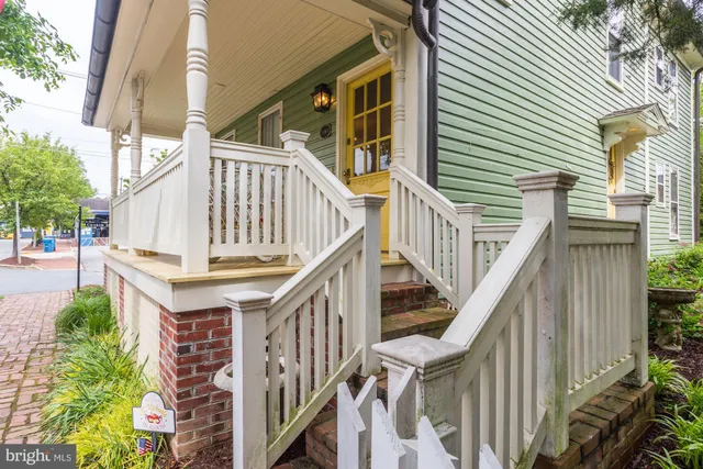 a view of wooden house with wooden stairs and windows