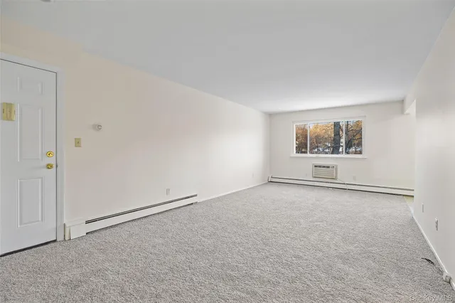 a view of an empty room and a window