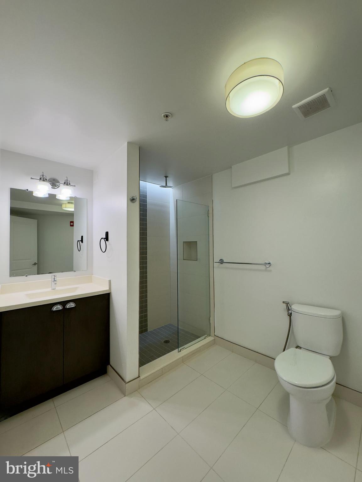 613 Portland Street, Unit 17 Baltimore, MD 21230 - Photo 7 of 12 a spacious bathroom with a toilet sink and mirror