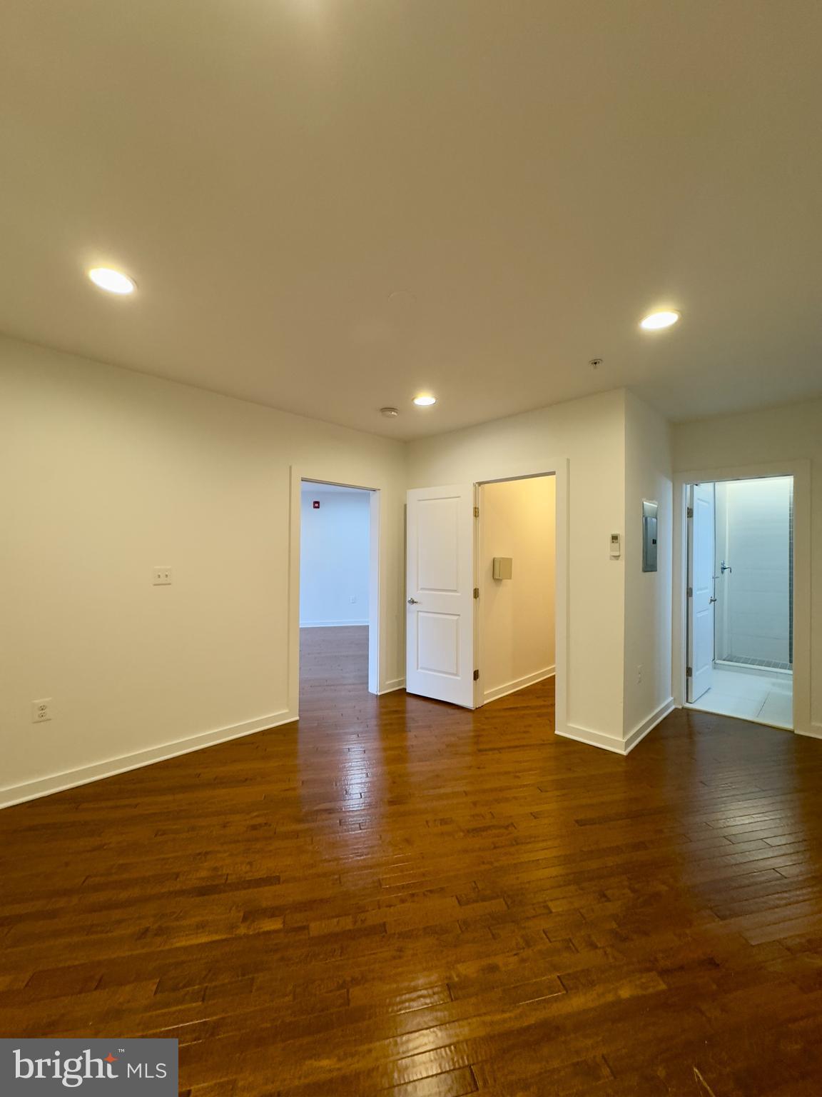 613 Portland Street, Unit 17 Baltimore, MD 21230 - Photo 9 of 12 a view of an empty room with wooden floor and windows