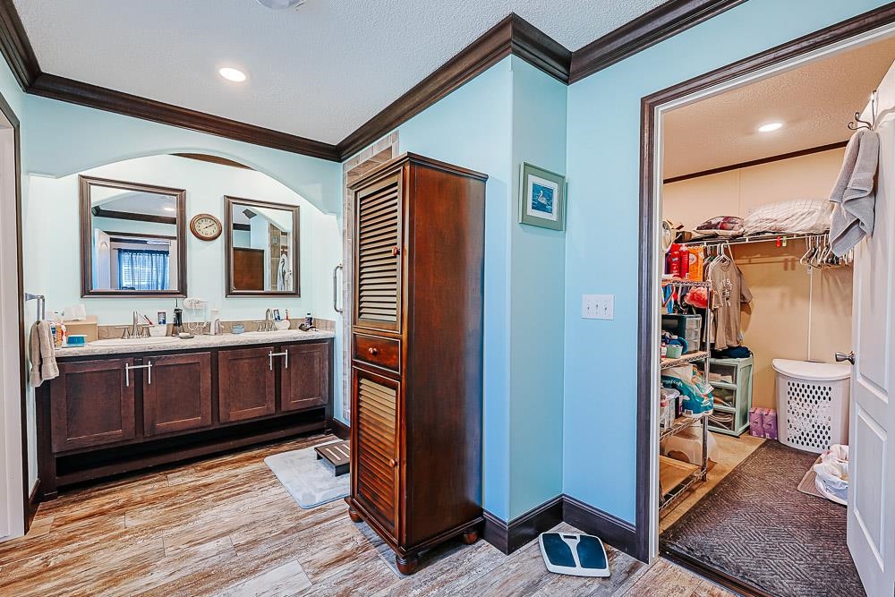 6773 Hampton Road Conway, SC 29527 - Photo 14 of 39 Full bathroom featuring double vanity, a spacious closet, Wood colored vinyl floors, ornamental molding, and recessed lighting