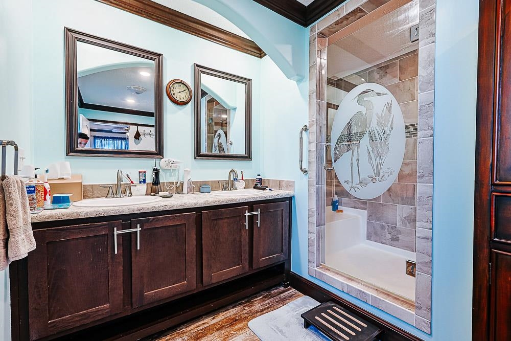 6773 Hampton Road Conway, SC 29527 - Photo 15 of 39 Full bathroom featuring crown molding, a stall shower, double vanity, wood colored vinyl flooring