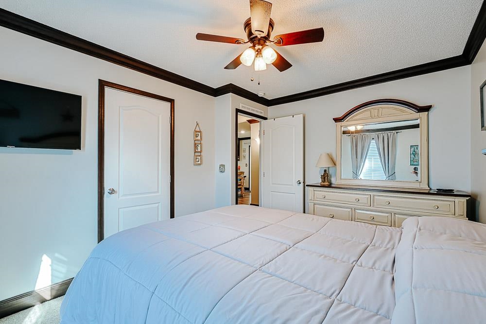 6773 Hampton Road Conway, SC 29527 - Photo 19 of 39 Bedroom with a ceiling fan and crown molding